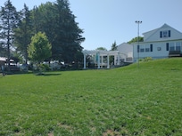 View of back of house, pergola and grounds.