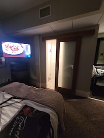 Roll door at foot of bed to enter bathroom.