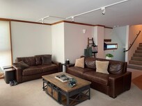 Leather couch and loveseat were comfortable and well placed for watching TV.