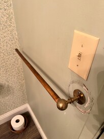 Broken towel holder hanging off wall upon arrival, no hardware.