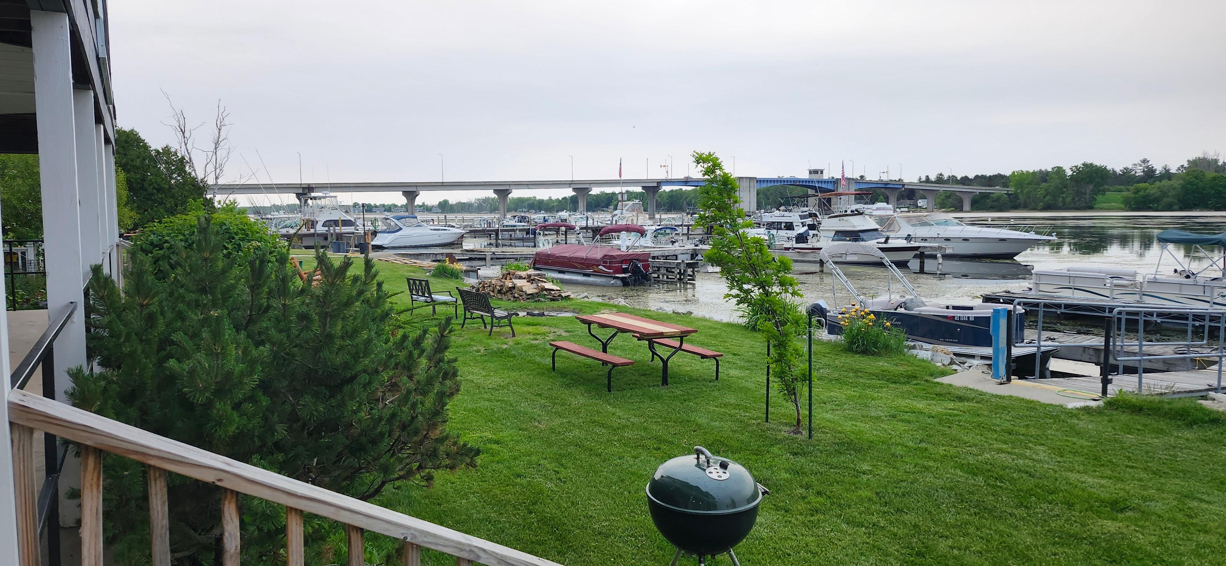 The yard has chaise lounge chairs, picnic tables...