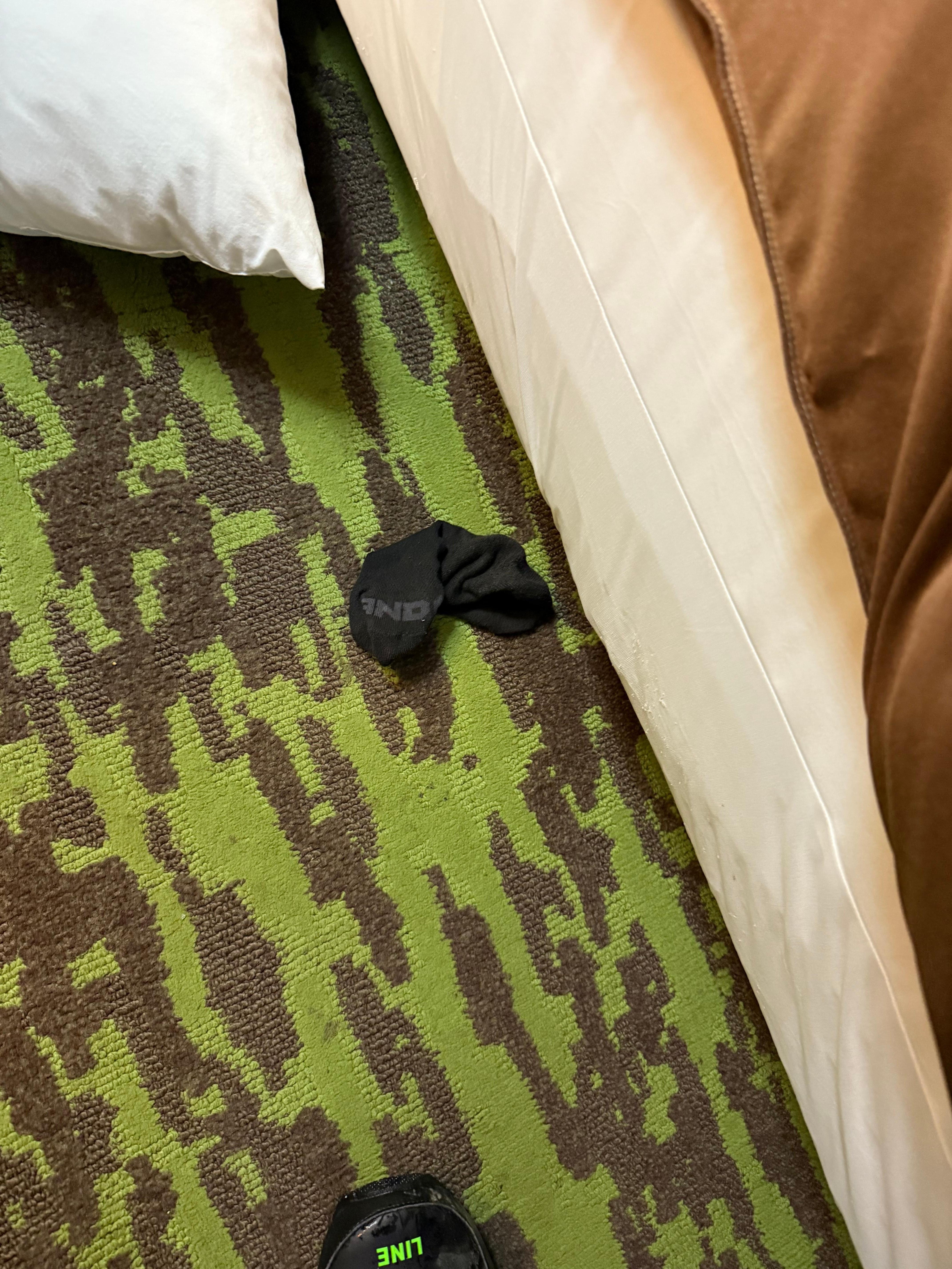 Dirty sock on floor upon arrival