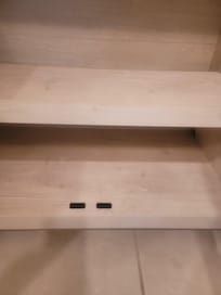 Someone draw with a crayon or marker on shelves