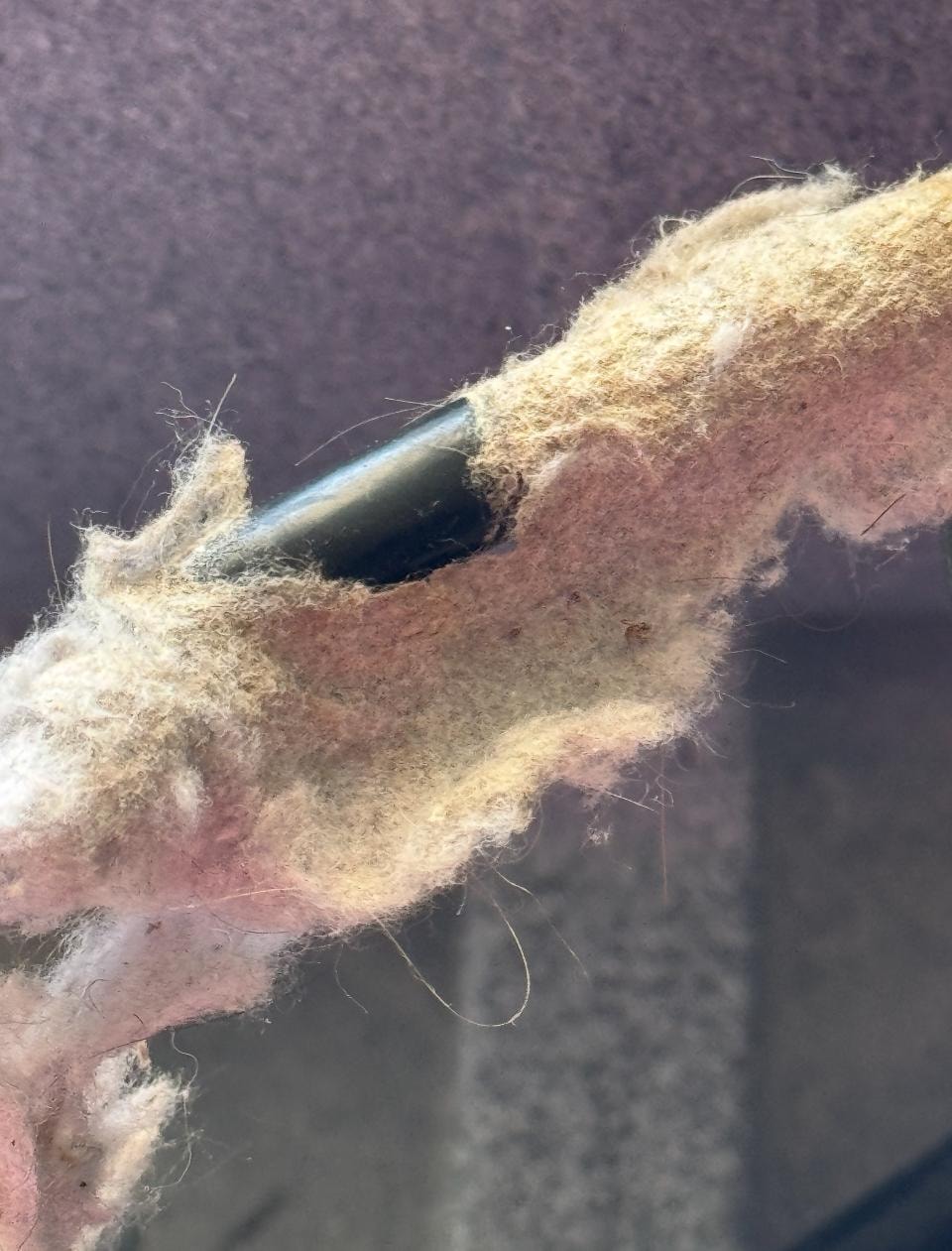 Close a view of the insulation that blew all over the room when we turn the fan on