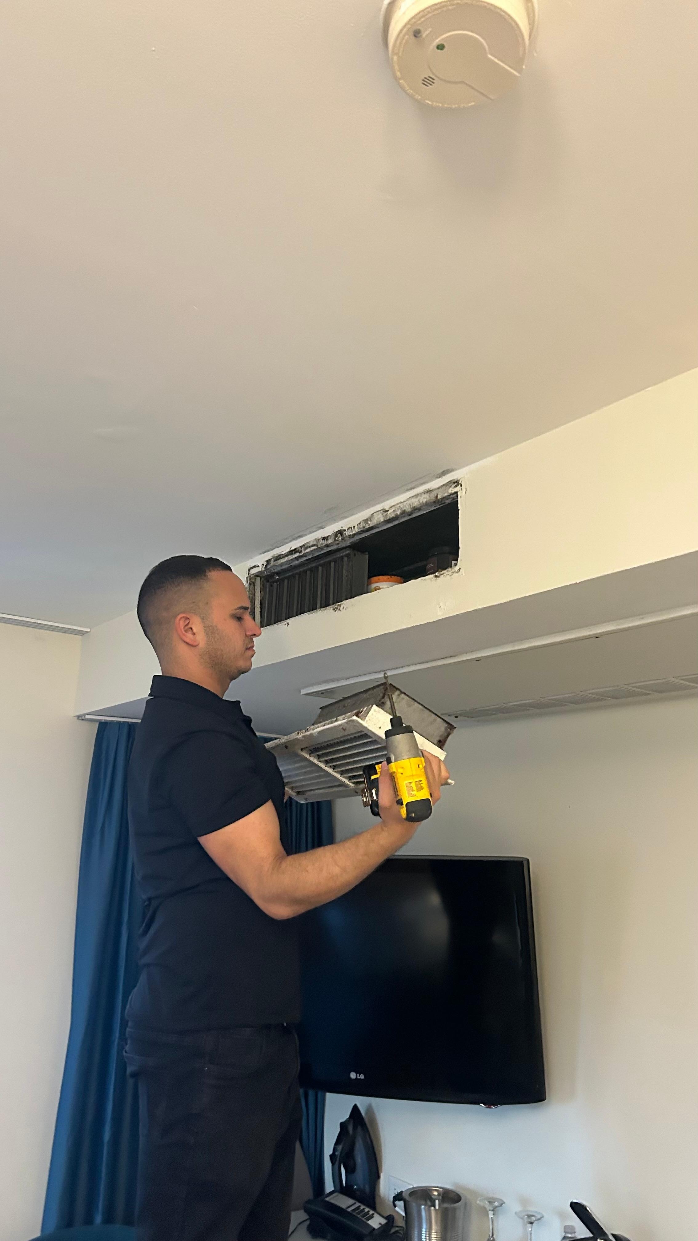 Maintenance man taking the register vent covered in mold off, he also washed the mold off the outside quickly after this photo 
