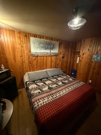 Comfy bed and room with a mini fridge