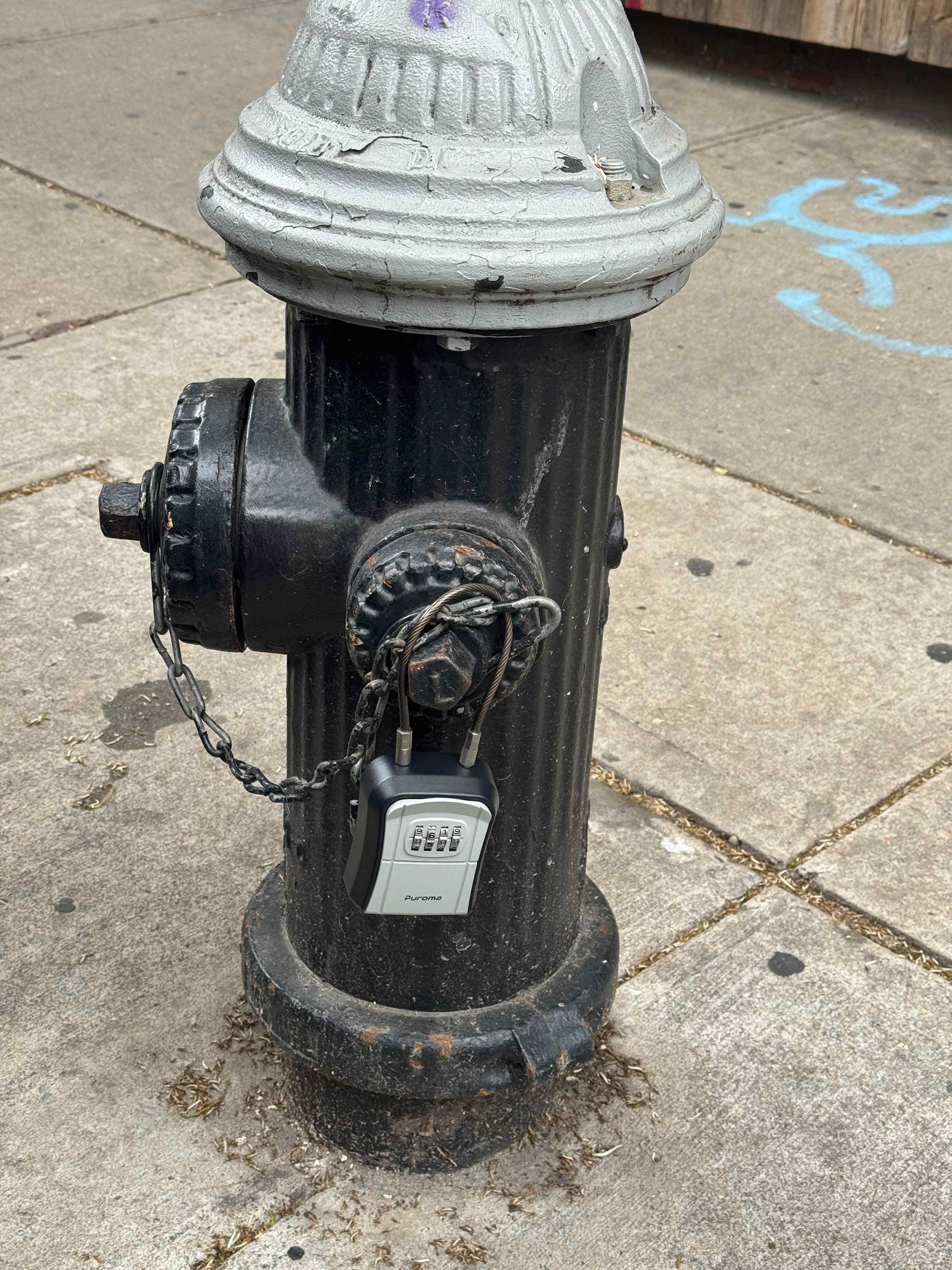Lockbox chained to a city fire hydrant across the street from the unit