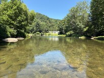 Standing in the middle of the river directly in front of the house looking left towards the blue hole.