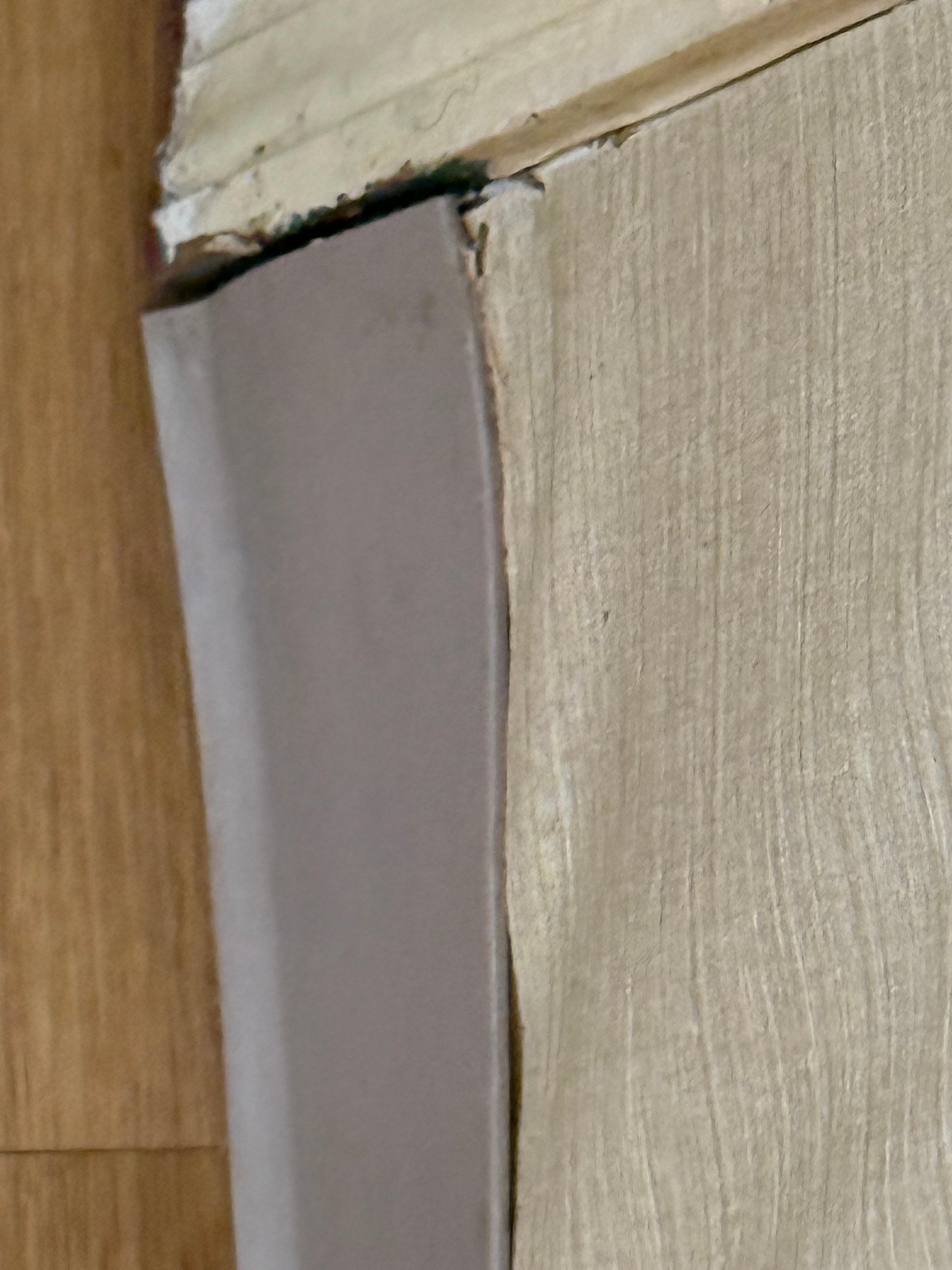 Separation by the door hidden by wall paper.