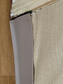 Separation by the door hidden by wall paper.