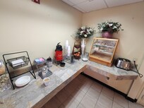 Continental breakfast. There were two dry cereal dispensers too the left, a beverage cooler and waffle maker to the right.