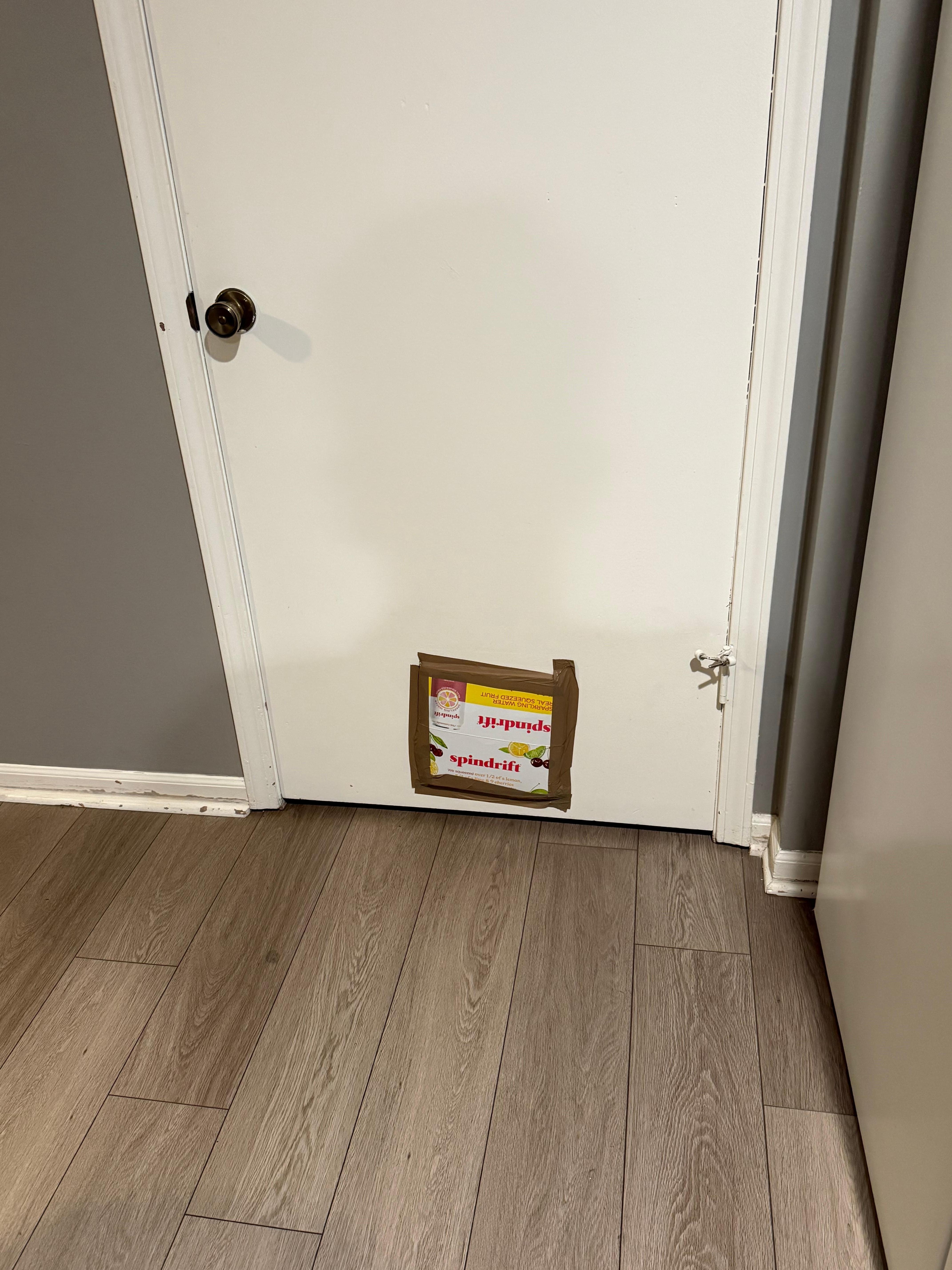 A box is covering a hole in the door in the kitchen