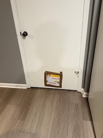 A box is covering a hole in the door in the kitchen