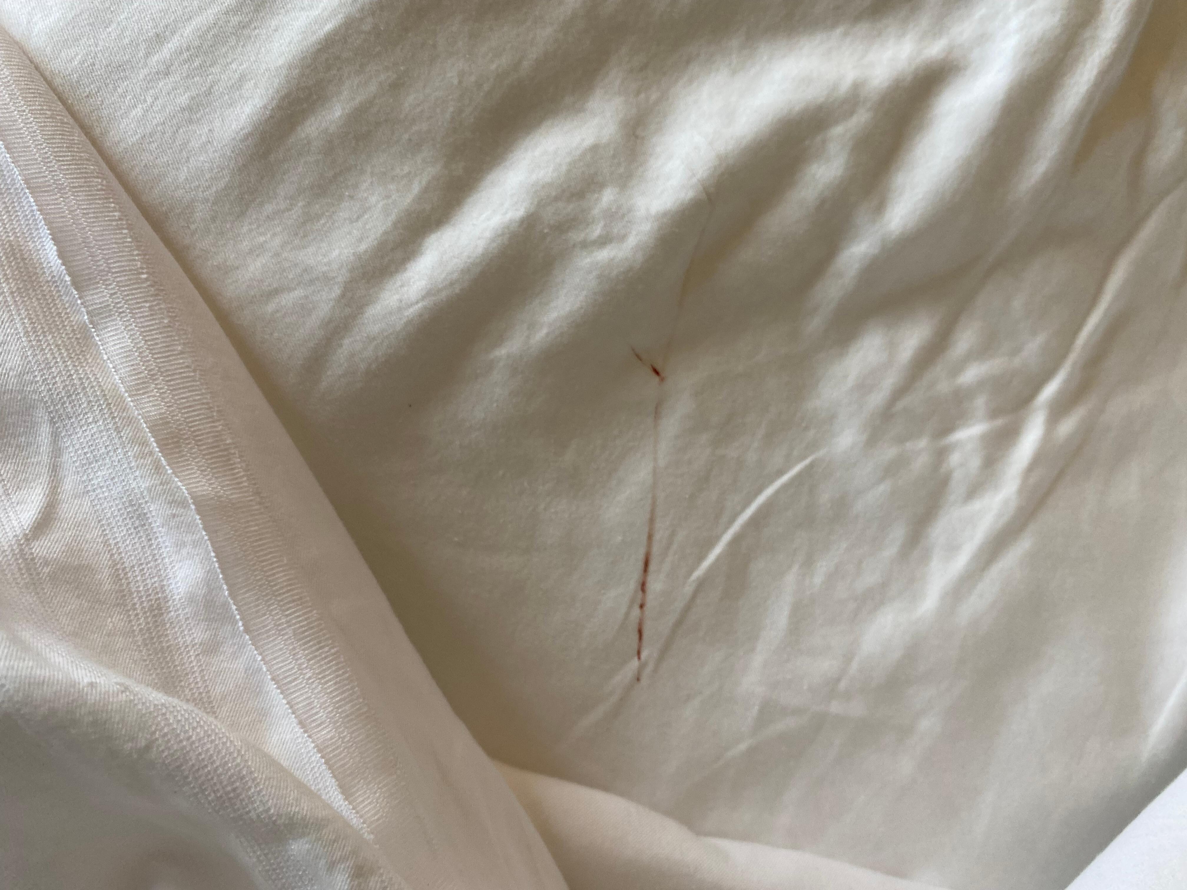 Stain at the foot of the bed. 