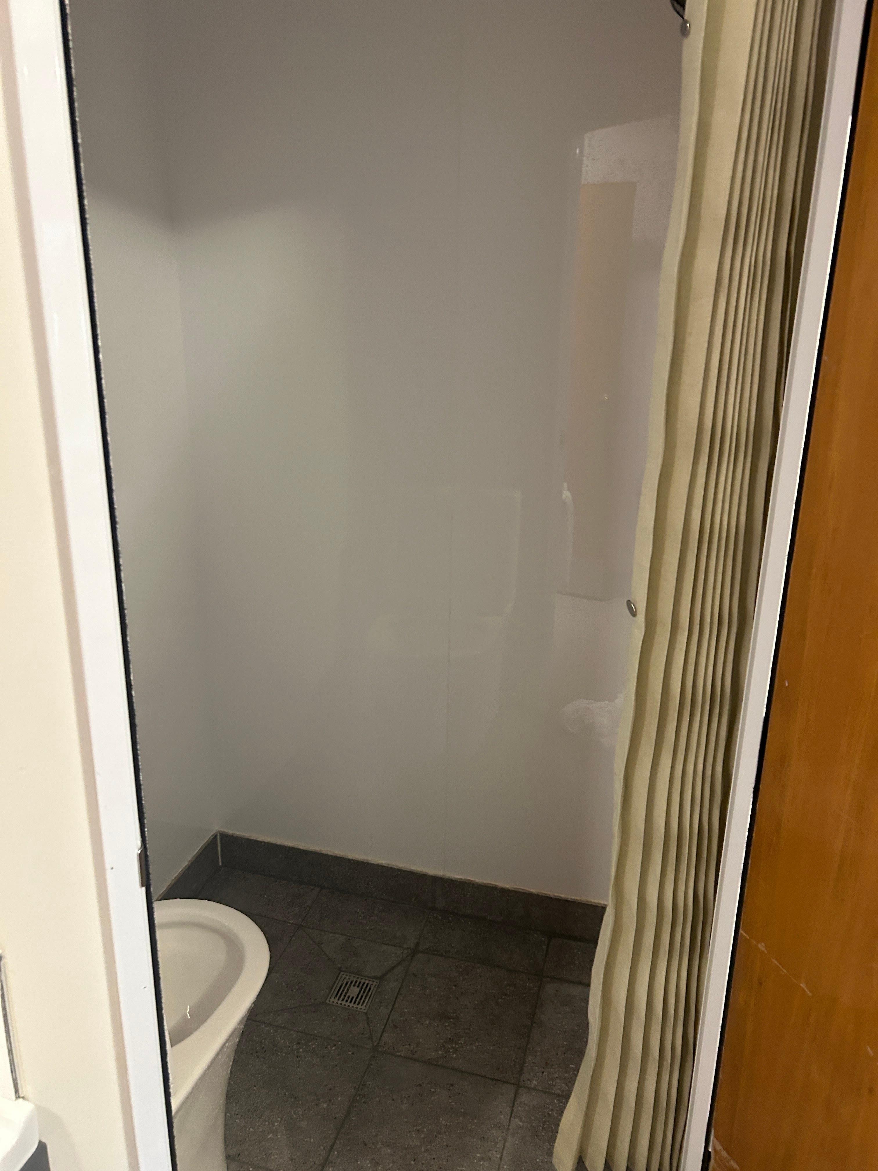 The shower and toilet were in the same little cubicle.  No sink in the bathroom.  Toilet covered in water