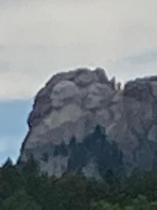 Zoomed in view of Rushmore from the hotel parking lot