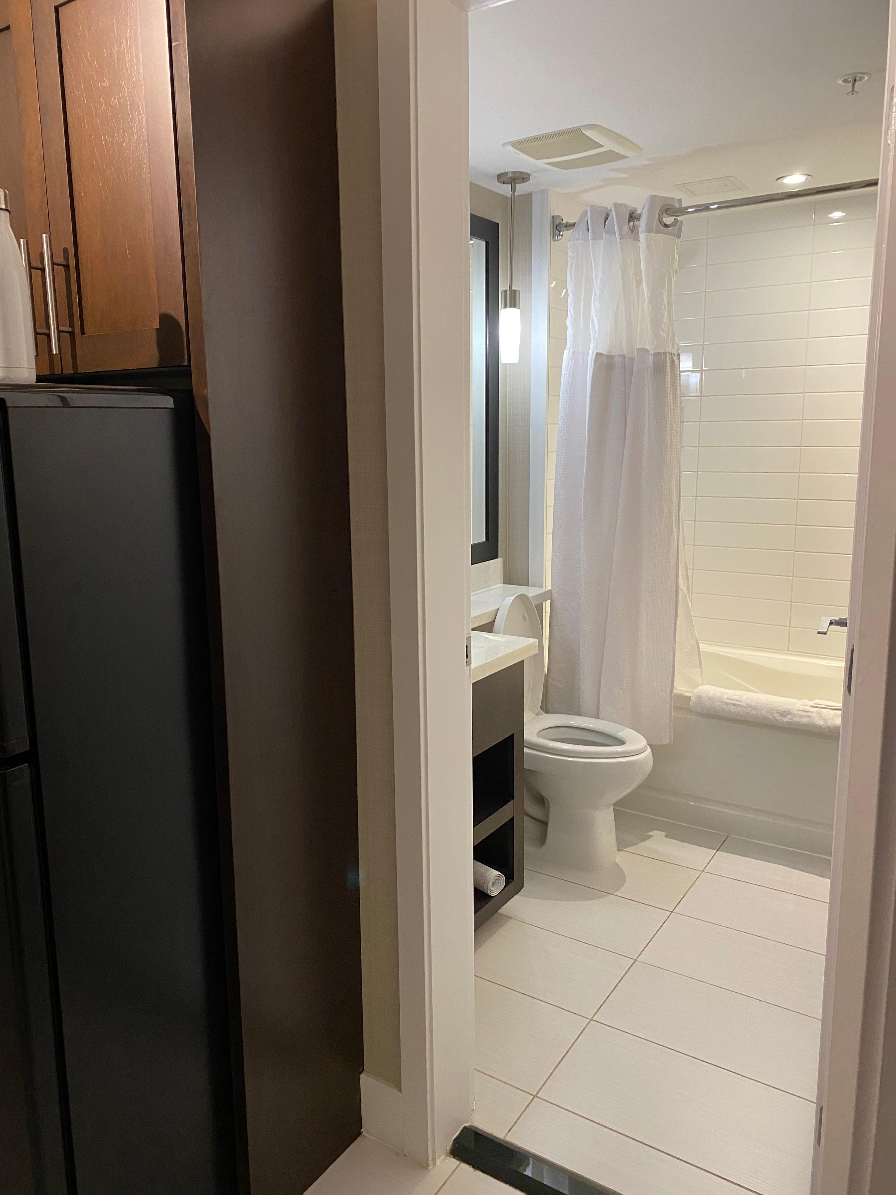 Bathroom is clean with bathtub/shower combo. 