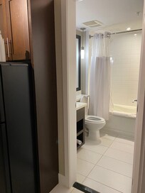 Bathroom is clean with bathtub/shower combo.