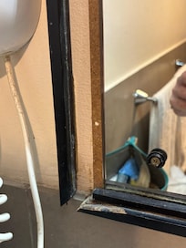 Bathroom mirror room 104. Literally falling apart.