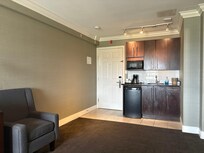 Kitchenette and chair. Hallway light shines in under the door