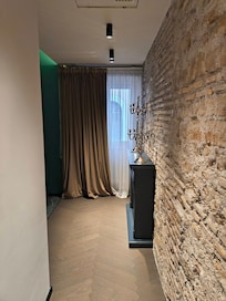 Entering into the suite - if you go straight, there is a fireplace and the stone is the original material from the historic building
