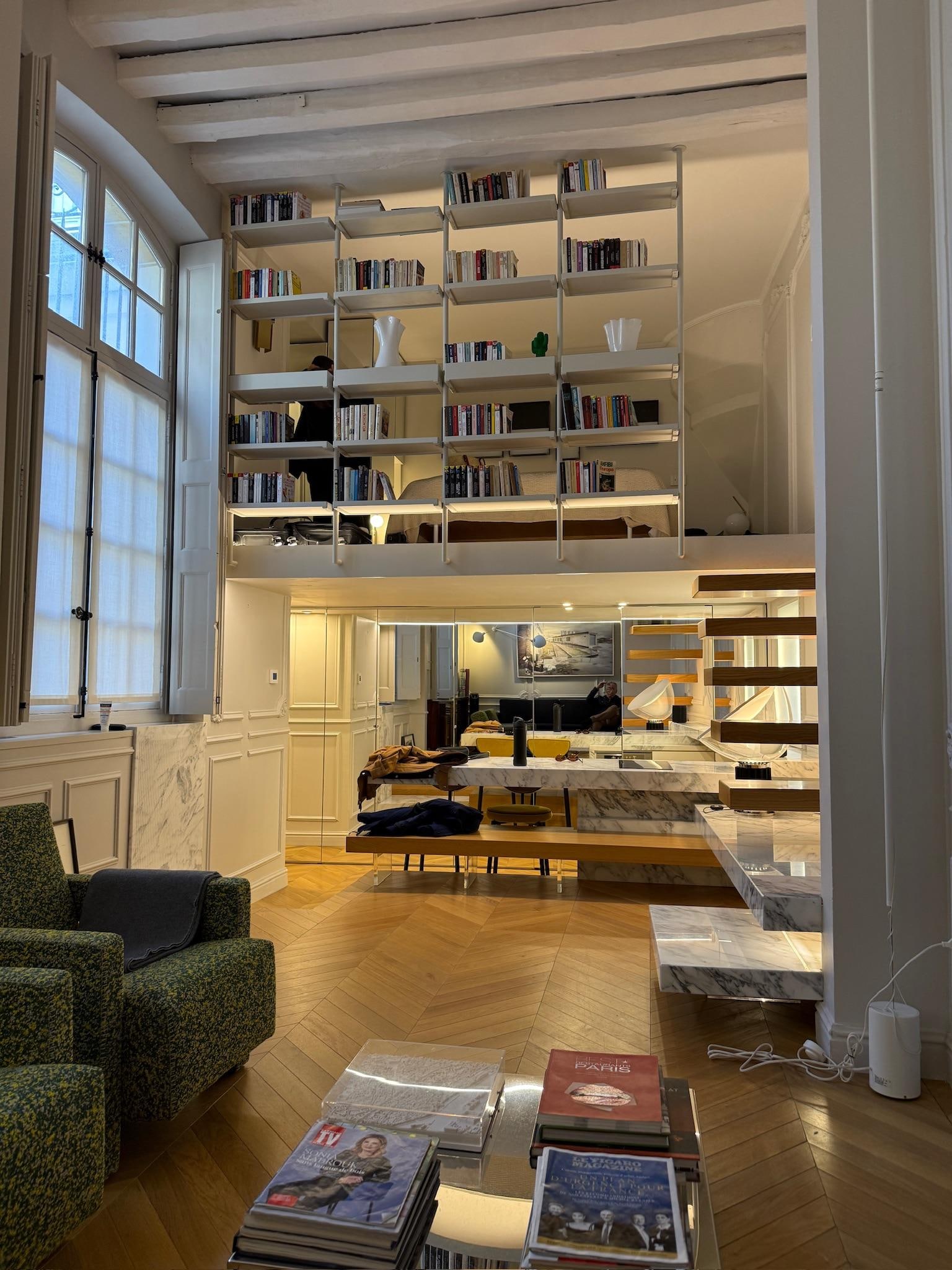 View from the couch looking at the kitchen on the lower level and the bedroom on the upper level 
