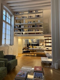 View from the couch looking at the kitchen on the lower level and the bedroom on the upper level