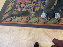 Rugs in all of the common areas were shabby, stained, and taped to the floor.