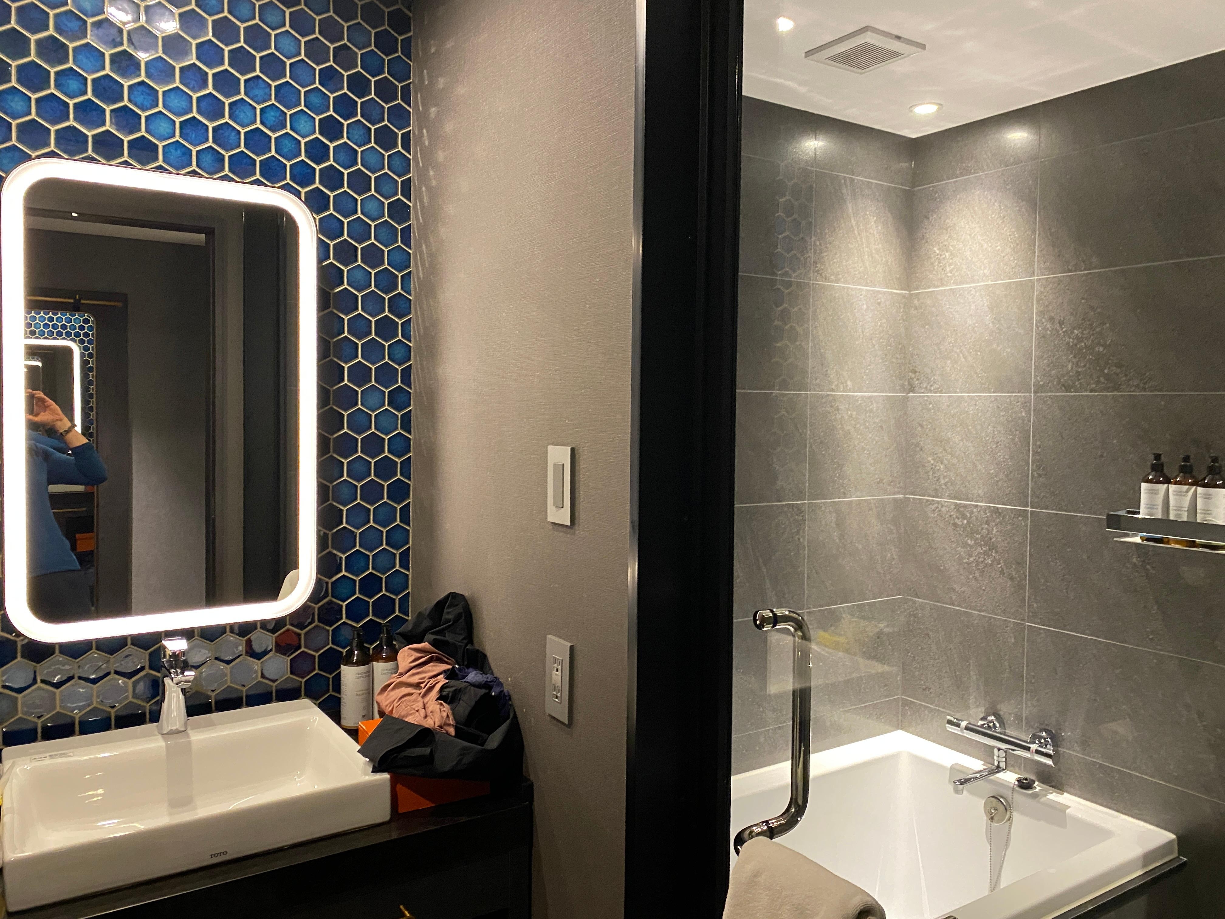 Modern bathroom with all the necessary amenities. Pretty blue tiles are a nice welcome.