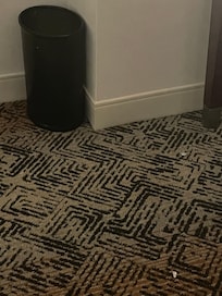 2 gum wrappers on the floor near trash can and no trash bags in trash can!