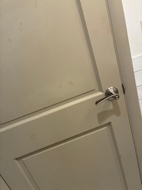 Dirty fingerprints all over the door, slightly reddish brown in color