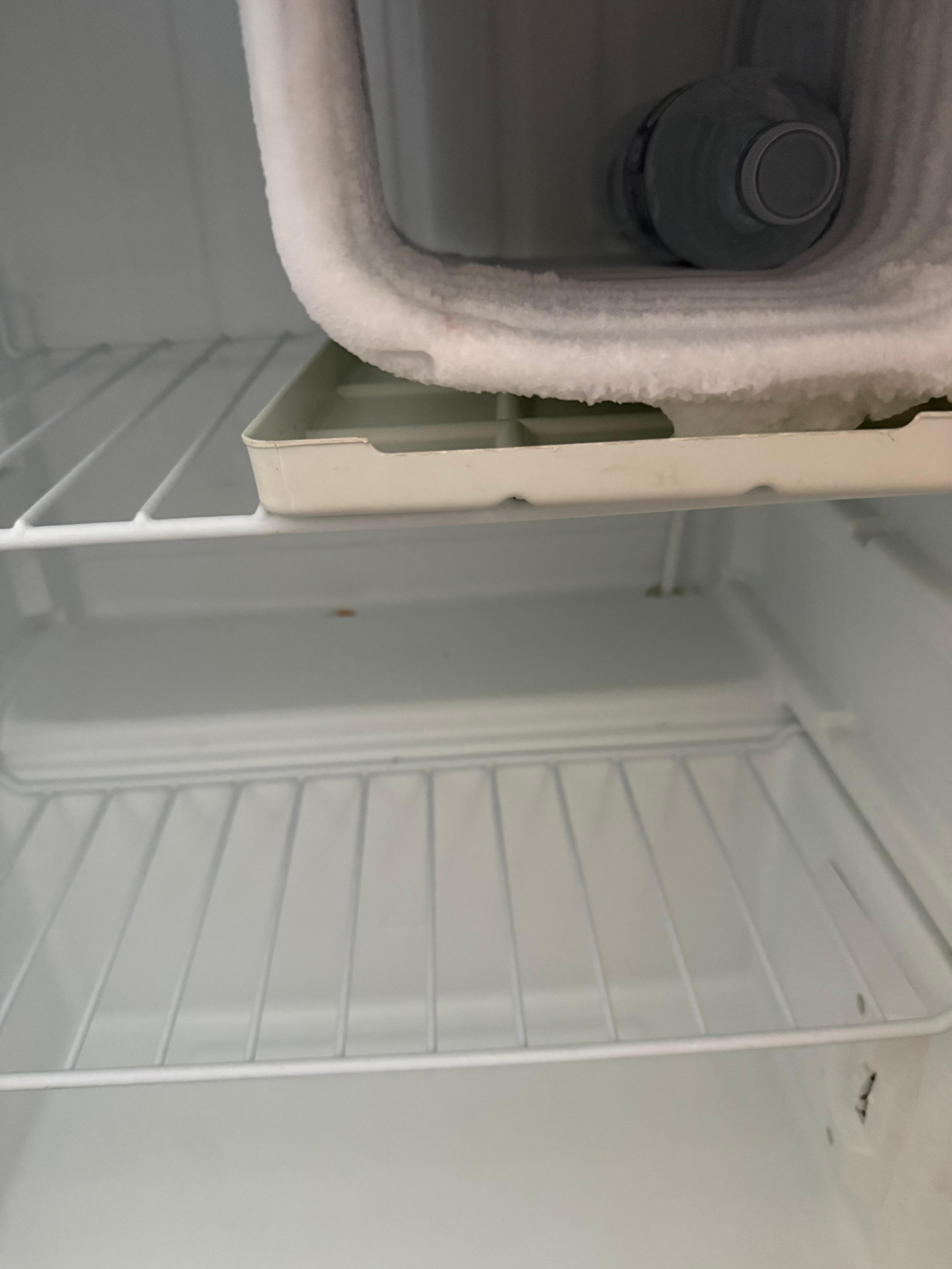 Broken fridge/freezer with a water left in it