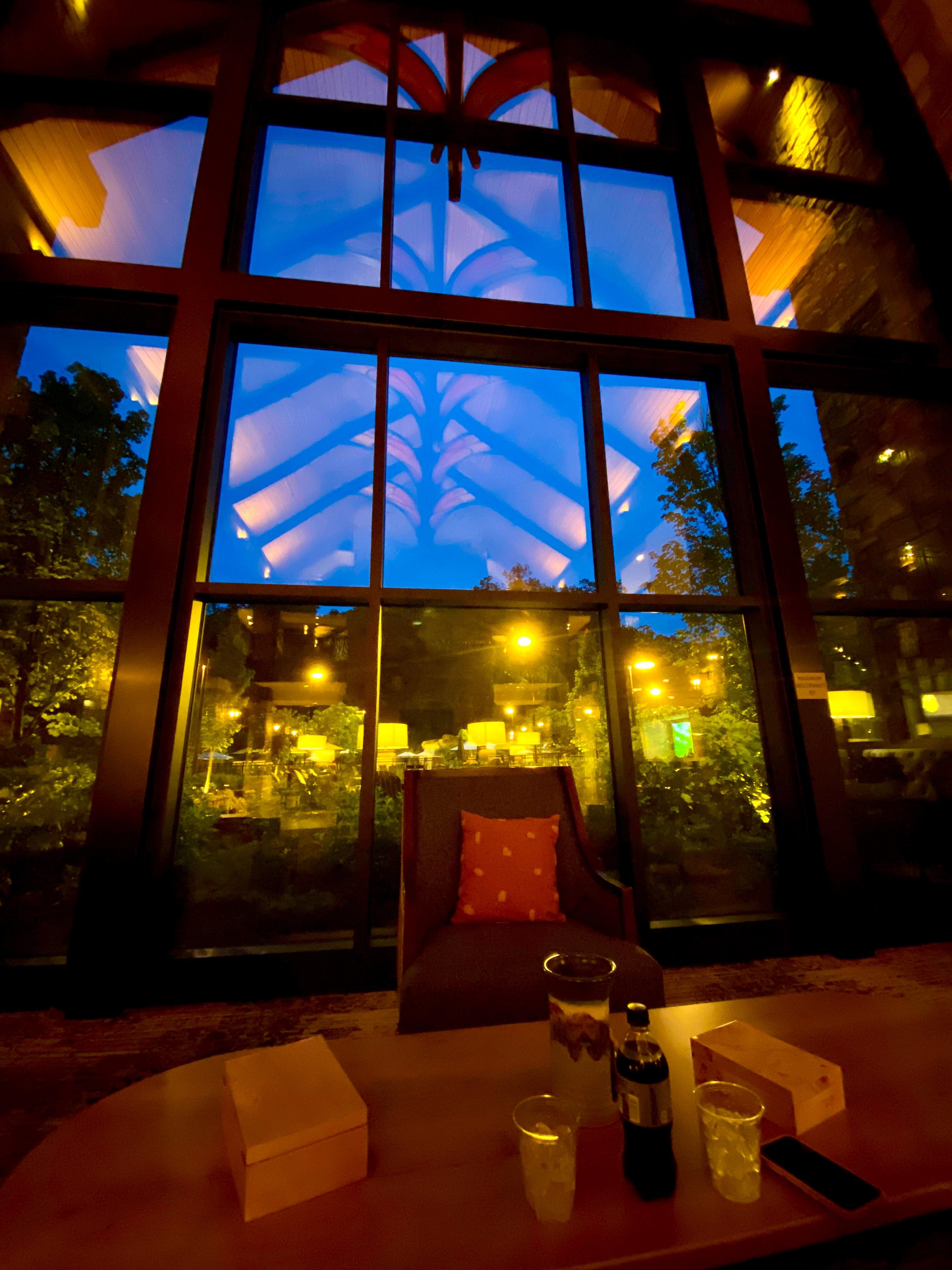 Massive window in the lobby looking out to the pool and fire pits in the back.