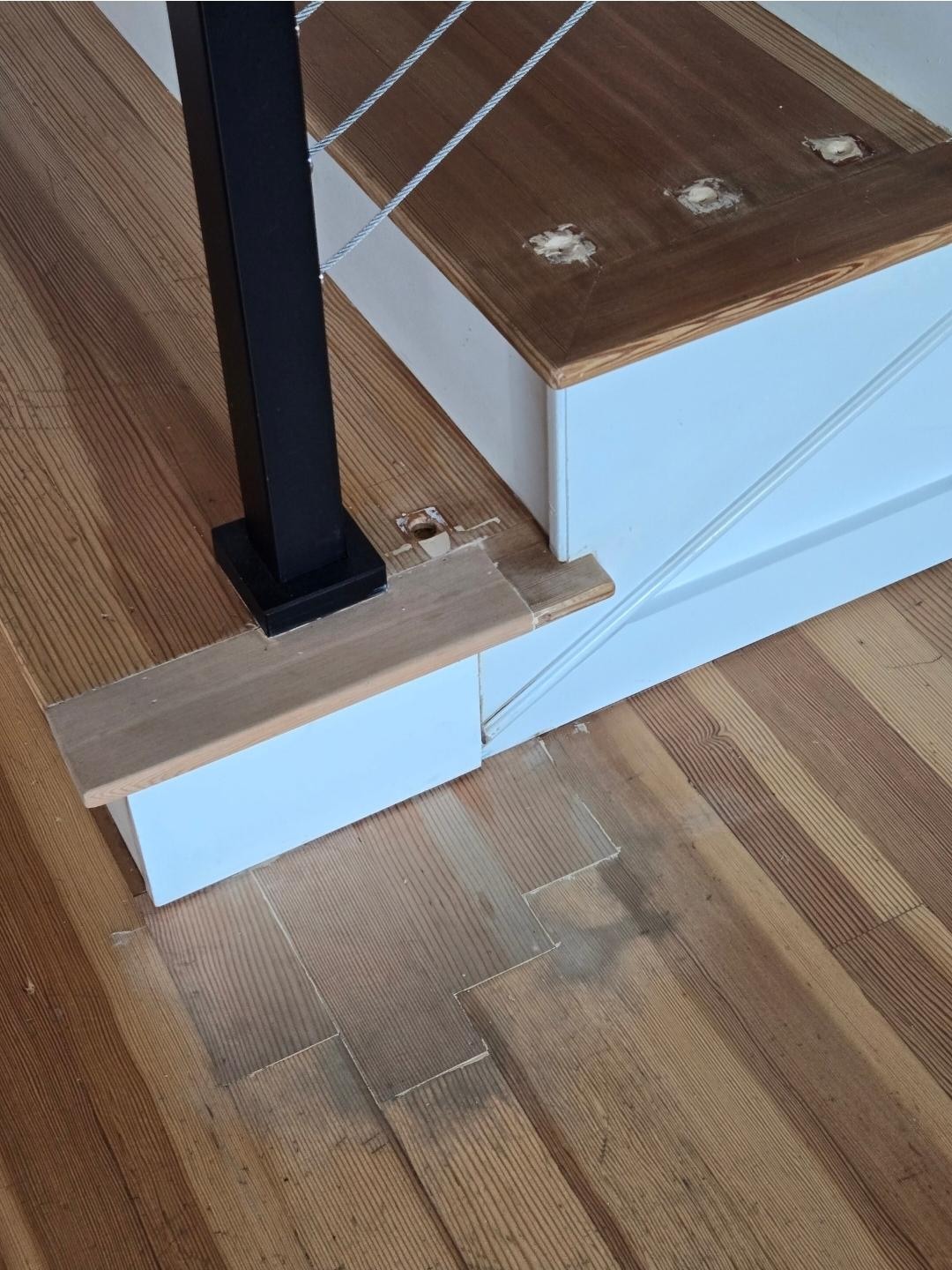 Putty up the staircase, raw wood, floor not done