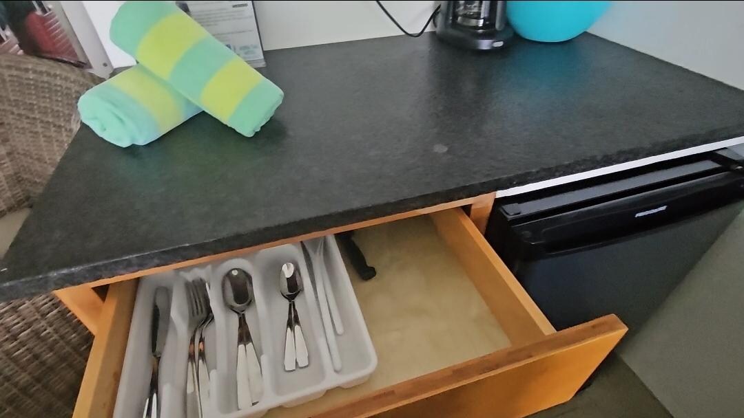 Cutlery, mugs, cups are in the cabinet and drawers along with electric water kettle. A good size fridge and microwave and coffee maker (bring your own coffee).