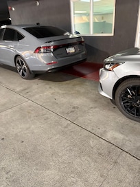 Parked in red zone, blocking vehicles from backing out of parking spots.