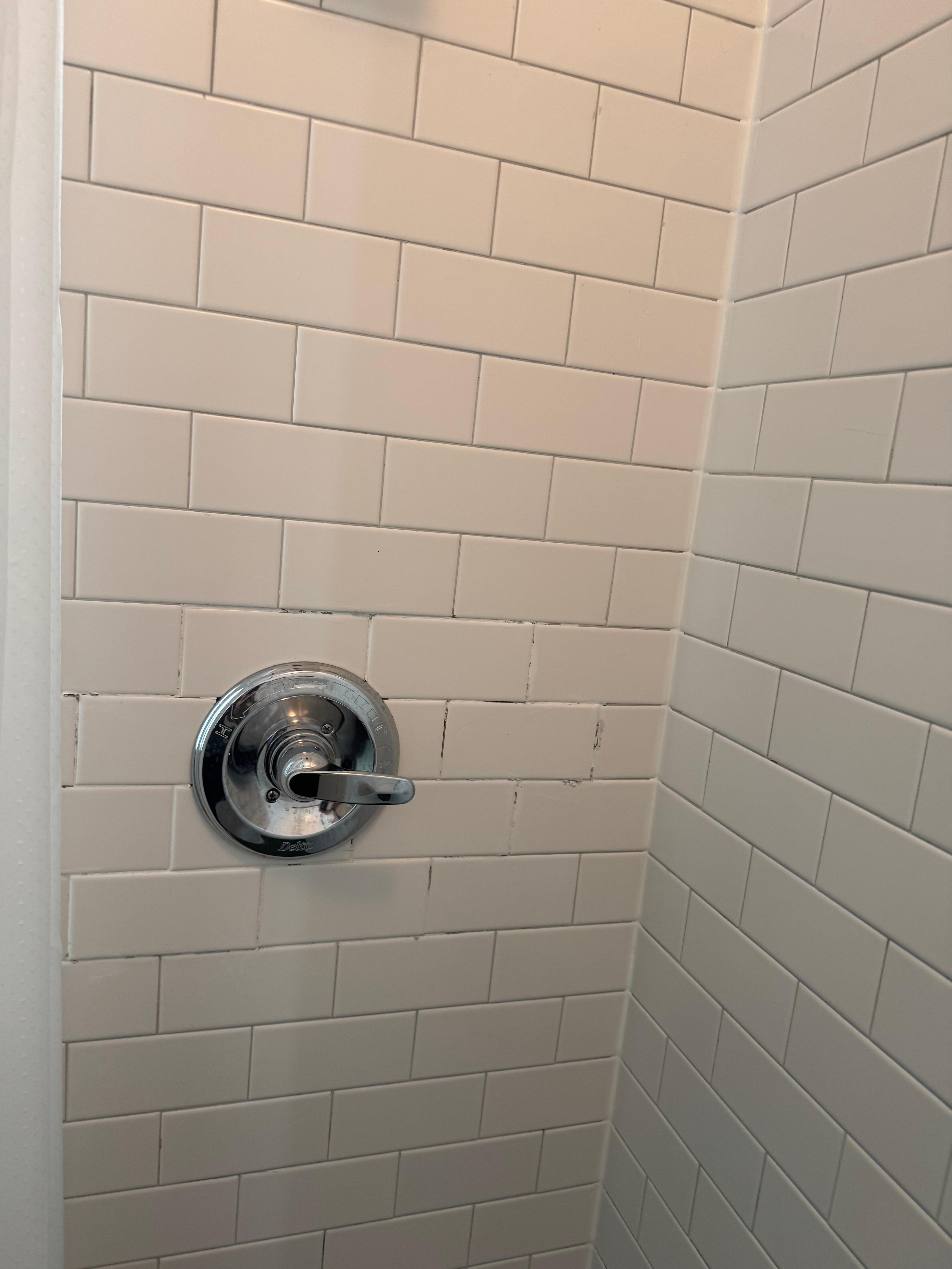 Tile in the bathroom clearly has been damaged and repaired very poorly. The bathroom ceiling paint was peeling and cracked.  