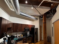 See the open ceiling here. The kitchen is spacious and well stocked.