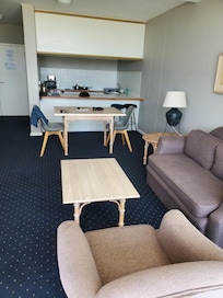 Seaside living room & kitchen in background