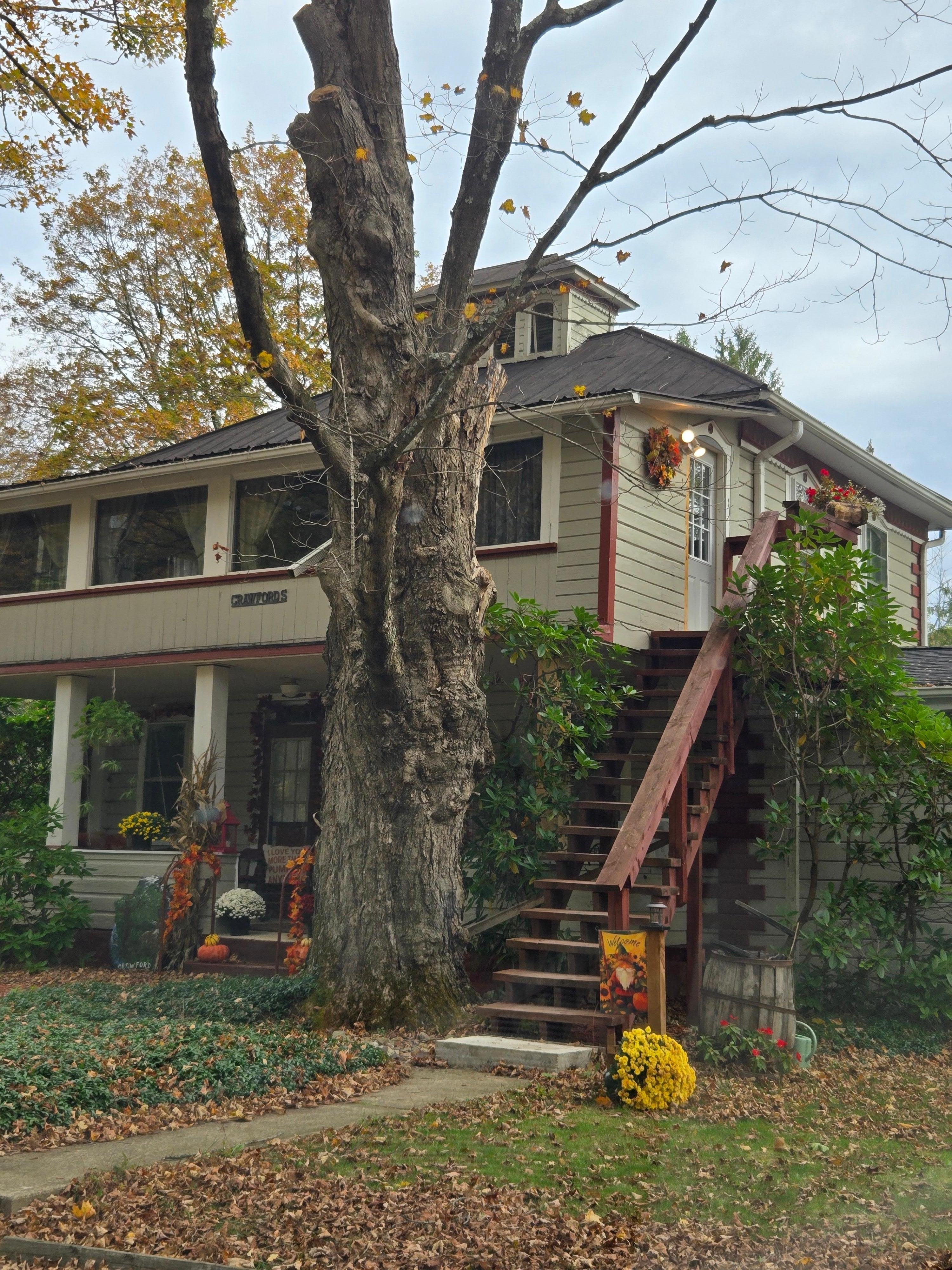 Stairs to enter the apartment are to the right of the home. 