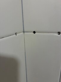 Holes in shower wall