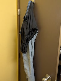 Someone 's pants and underwear were hanging on the bathroom door when we arrived at the room