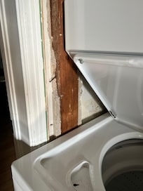 Bare wall around washer dryer.
