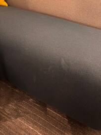 Nasty questionable stains on sofa in room.