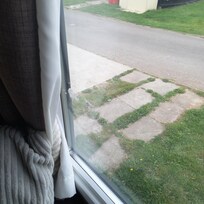 dirty windows with hand prints and dried on tissue.