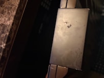 Handle on the cabinet that contains the fridge