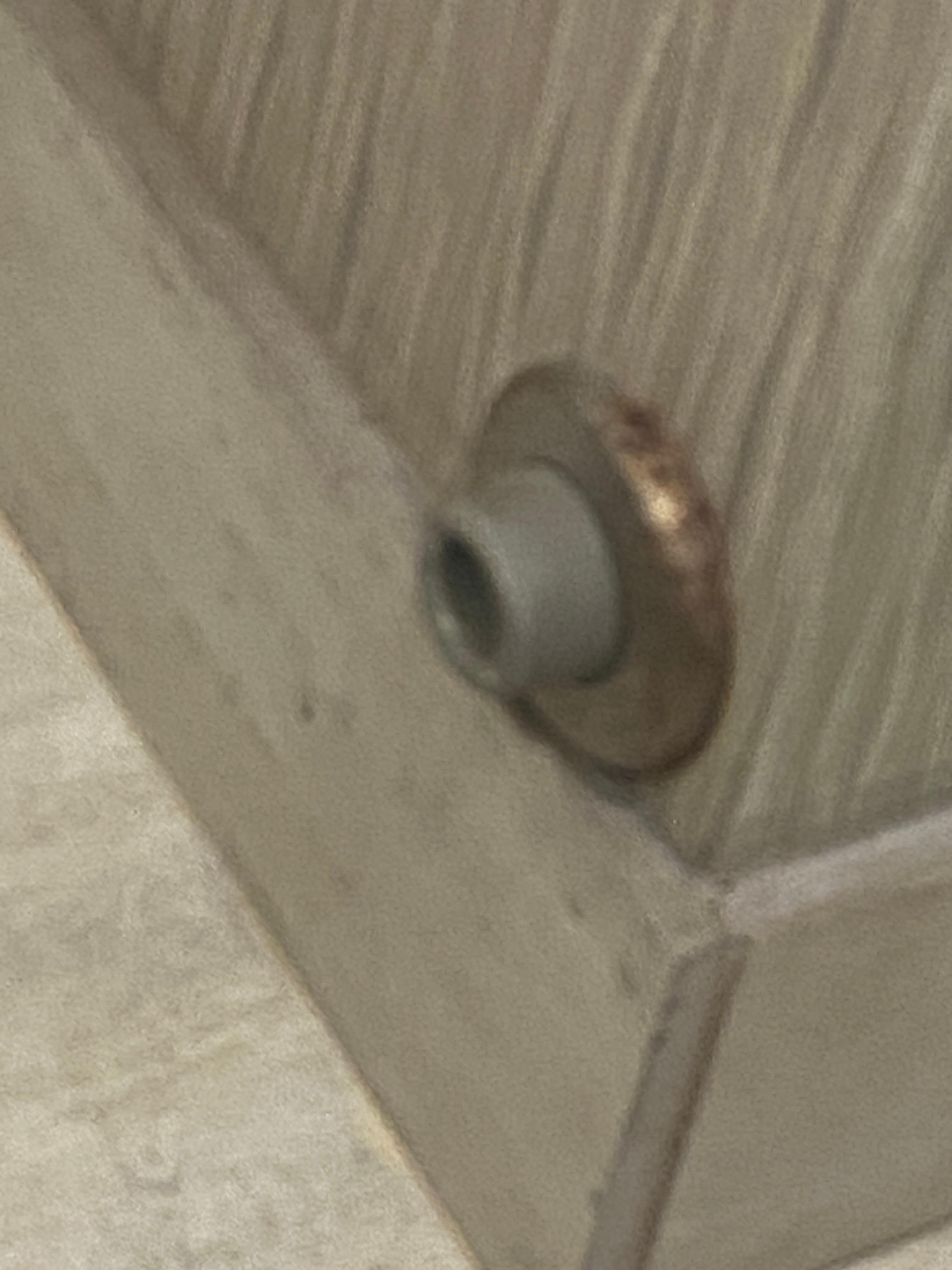 Rusted door stop dirty. 