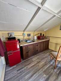 They have a camping kitchen that they open early and close at 10pm I believe. You can make coffee, microwave food, wash your dishes and use the fridge.