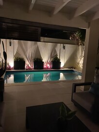Pool at night from inside living room.