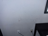 Stained Walls next to TV.